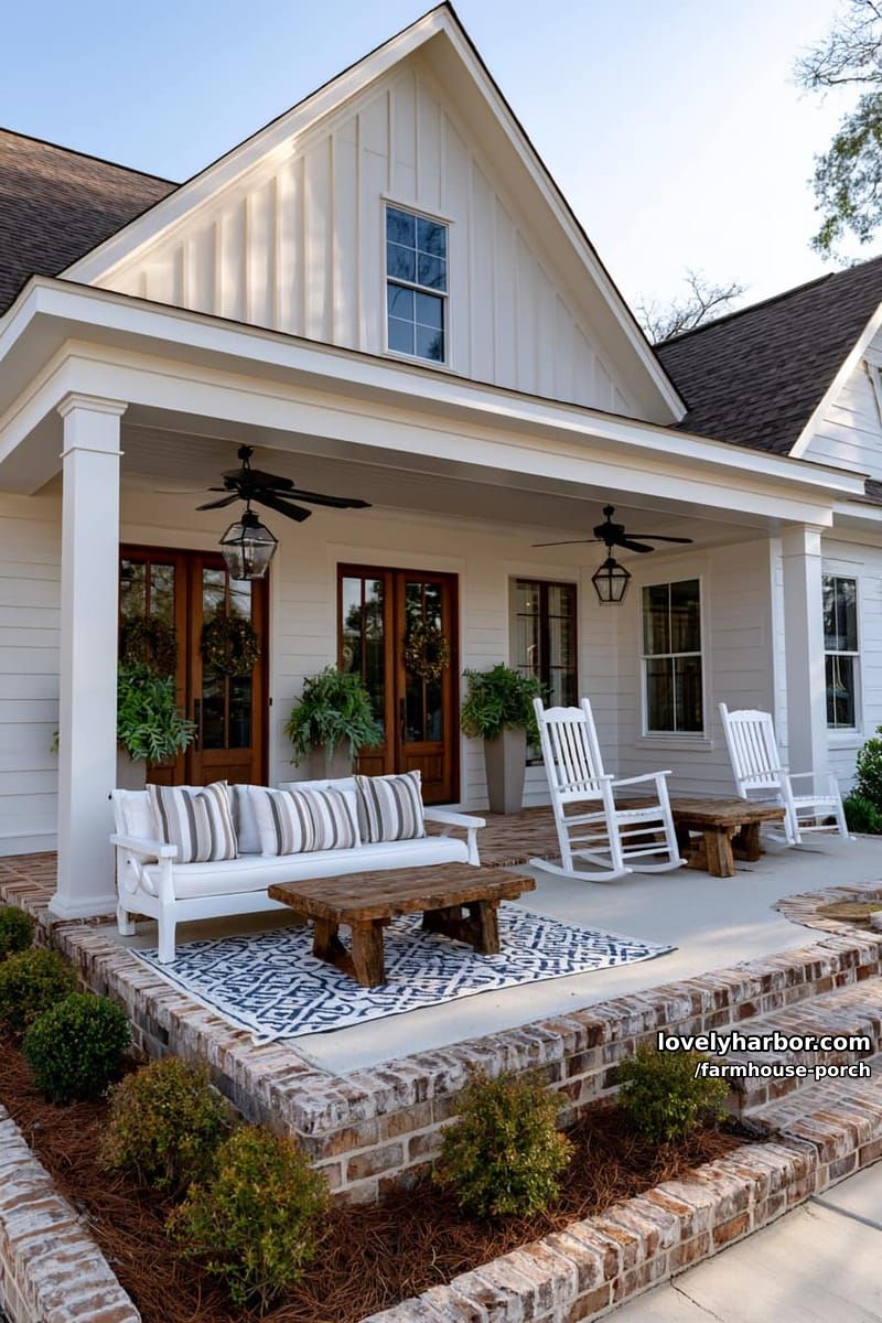 suburban porch with double doors, white outdoor furniture, striped cushions, and brick steps. 1