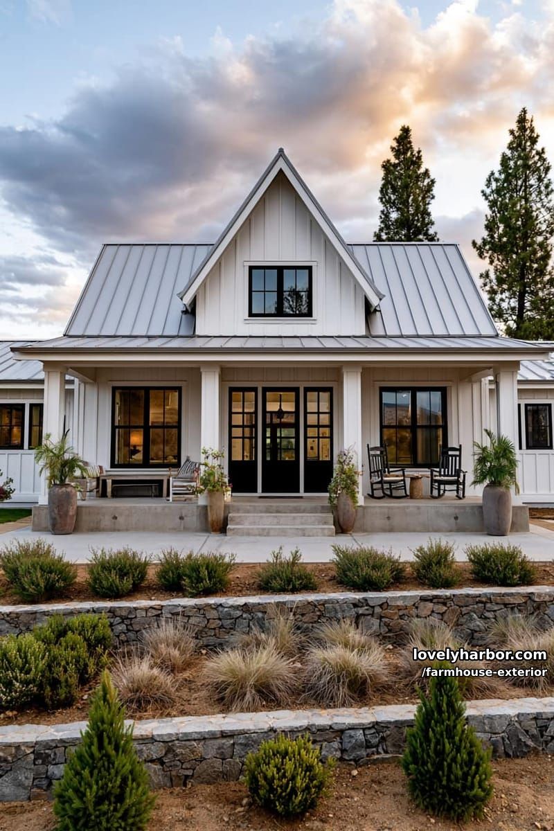 symmetrical farmhouse, central dormer, wide porch, tiered landscaping, setting sun. 1