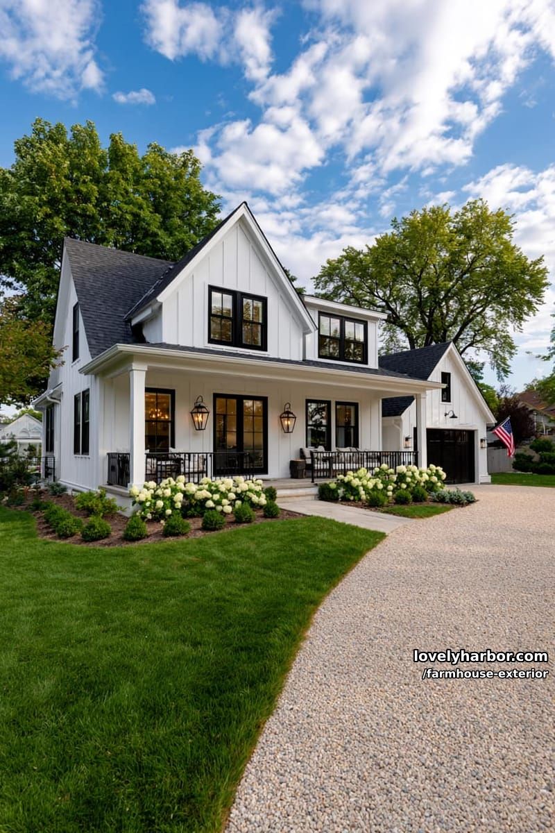 two-story white farmhouse, black railings, double doors, flag, manicured gardens. 1