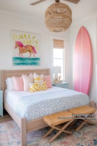 coastal cowgirl bedroom with floral quilt, woven benches, surfboard, and rattan accents 21