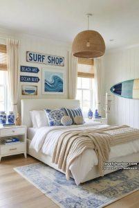 20 Chic Coastal Bedrooms with Relaxing Ambiance 4 coastal-themed bedroom with white bed, blue pillows, beach signs, and woven textures. 5