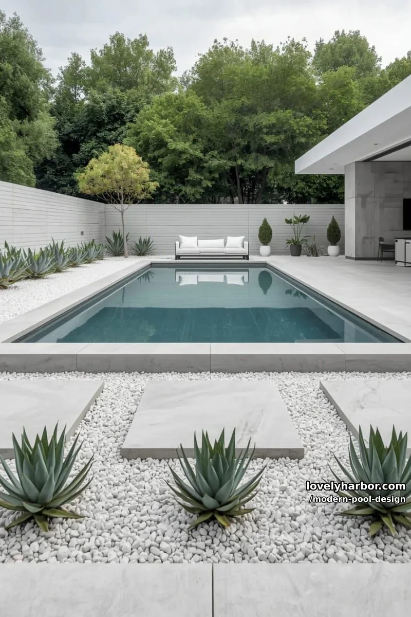 minimalist rectangular pool with concrete pavers, white gravel, succulents, and modern seating. 1