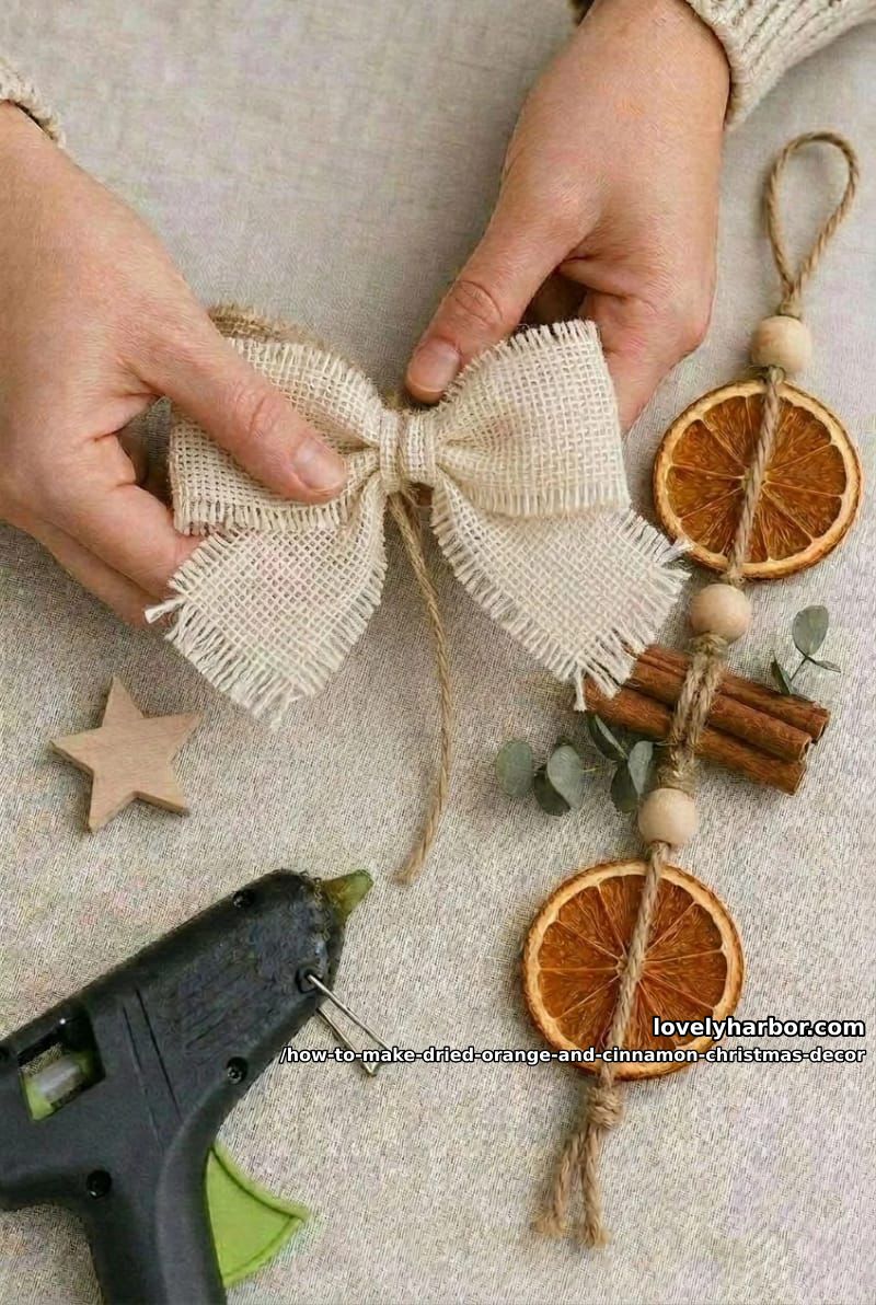 How to Make a Dried Orange and Cinnamon Christmas Hanging Ornament 10 step 5: tie the bow, add the star, hang 1