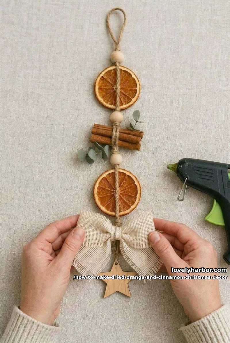 How to Make a Dried Orange and Cinnamon Christmas Hanging Ornament 11 step 5: tie the bow, add the star, hang 1