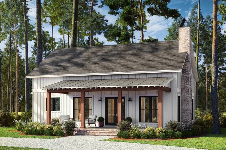 2-Bedroom Barndominium Cottage House Plan (1,320 Sq. Ft. Floor Plan) 1 Front view of a 2-bedroom barndominium cottage house plan featuring a white board and batten exterior, brick chimney, covered porch with wooden posts, and surrounding landscaping, representing a 1,320 sq. ft. floor plan.