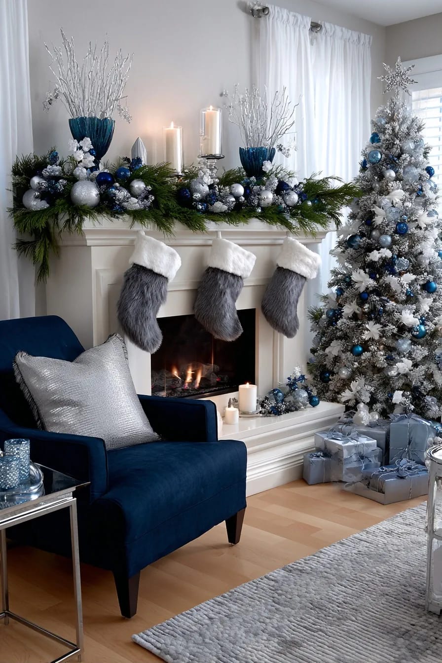 Blue and Silver Christmas Decor Ideas for the Living Room That Don't Read as Cold 12 Festive living room decorated with blue and silver Christmas decor, featuring a mantel with lush garland, ornaments, and candles, faux fur stockings, a flocked Christmas tree adorned with blue and silver ornaments, wrapped gifts, and a navy blue armchair with a silver pillow.
