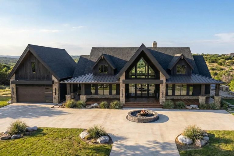 Modern mountain lodge home exterior with dark wood, stone, and front porch.