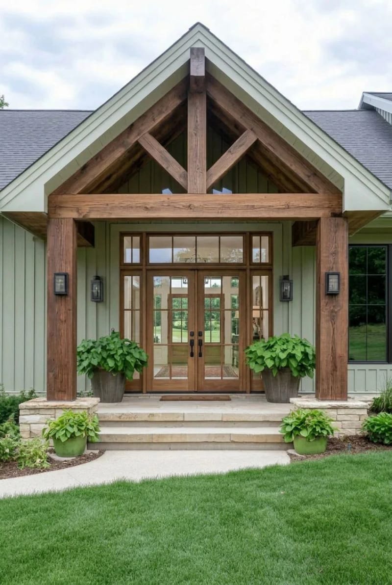 sage green modern farmhouse with rustic wooden posts and glass double doors. 1