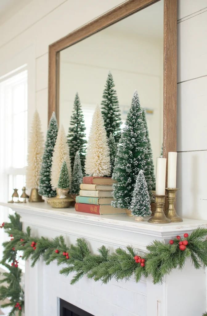 Farmhouse Christmas Mantel Decorating Ideas That Skip the Store-Bought Look 8 stagger bottlebrush trees on stacked books or a small riser 1