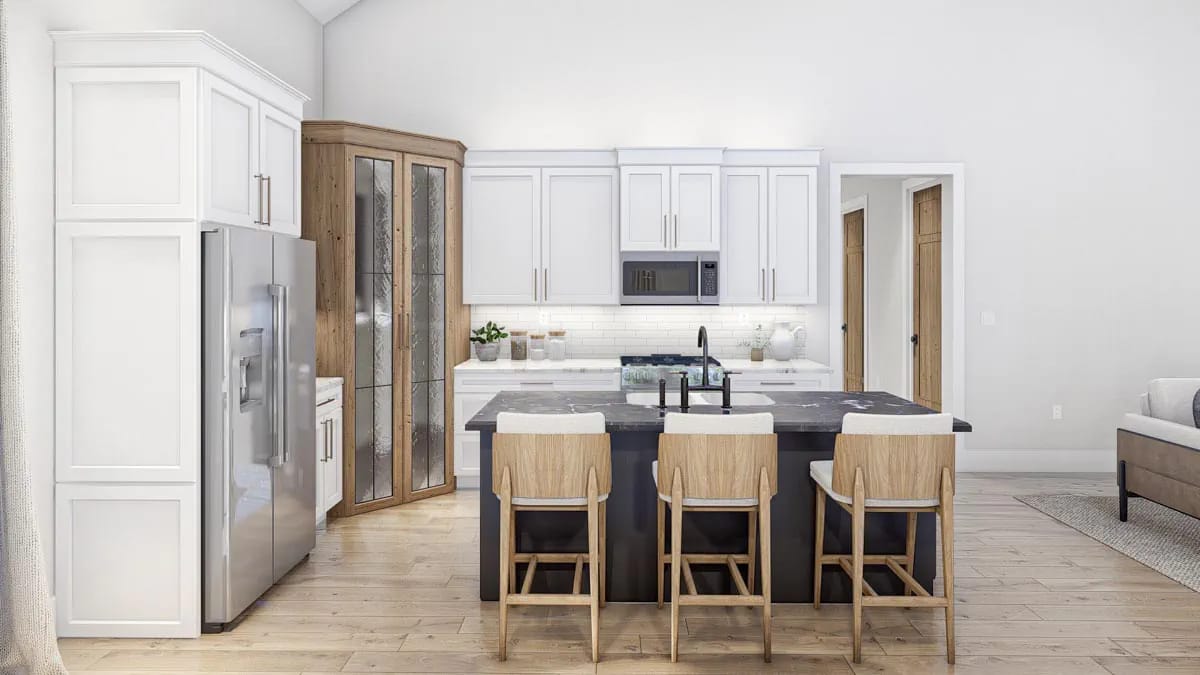 the kitchen: white shakers, a reeded-glass pantry tower, and a black marble waterfall island 1