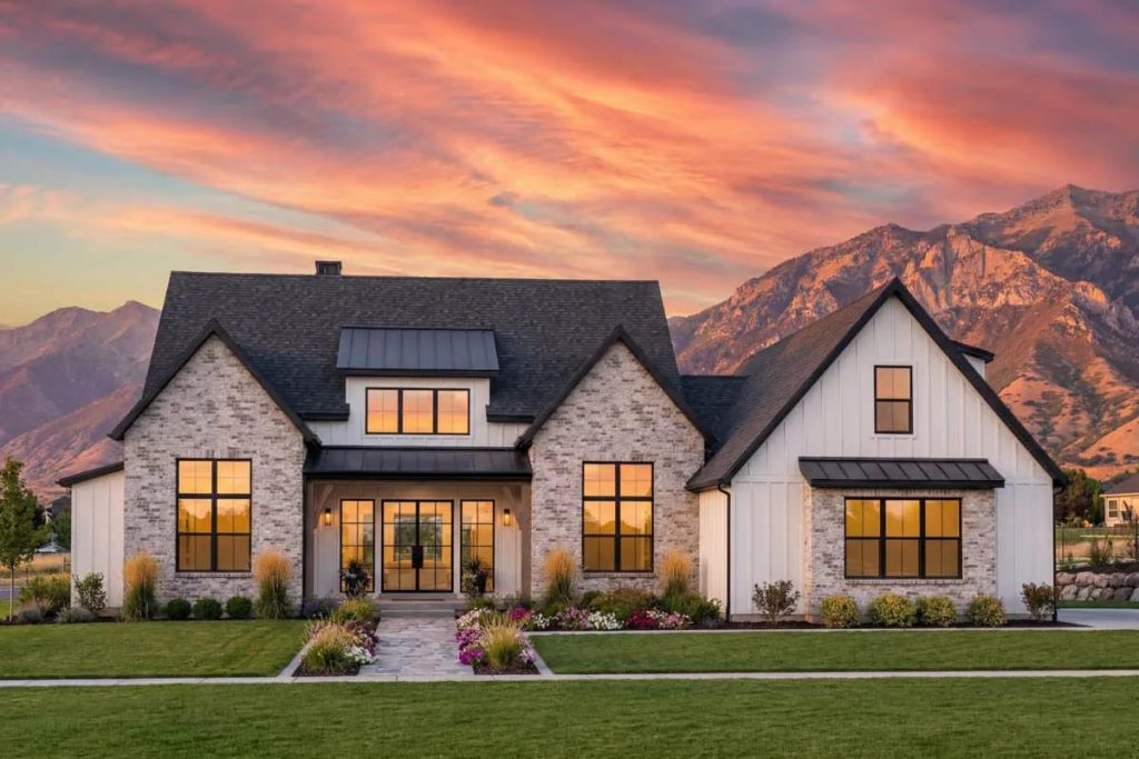 Modern farmhouse exterior with gabled roof, brick and board-and-batten siding, and large black-framed windows