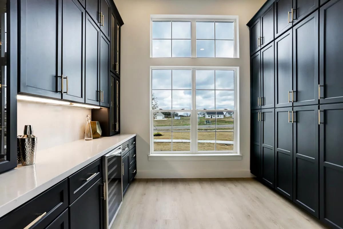 4-Bedroom Modern Farmhouse House Plan with a Vaulted Great Room and Bonus Room (2,877 Sq. Ft. Floor Plan) 9 a walk-in pantry with a window and a beverage fridge under the counter 1