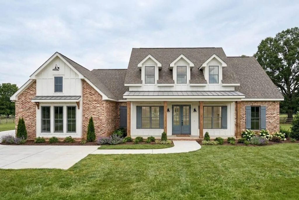 Lovely Harbor 47 Traditional farmhouse exterior with brick, board-and-batten siding, and a welcoming front porch.
