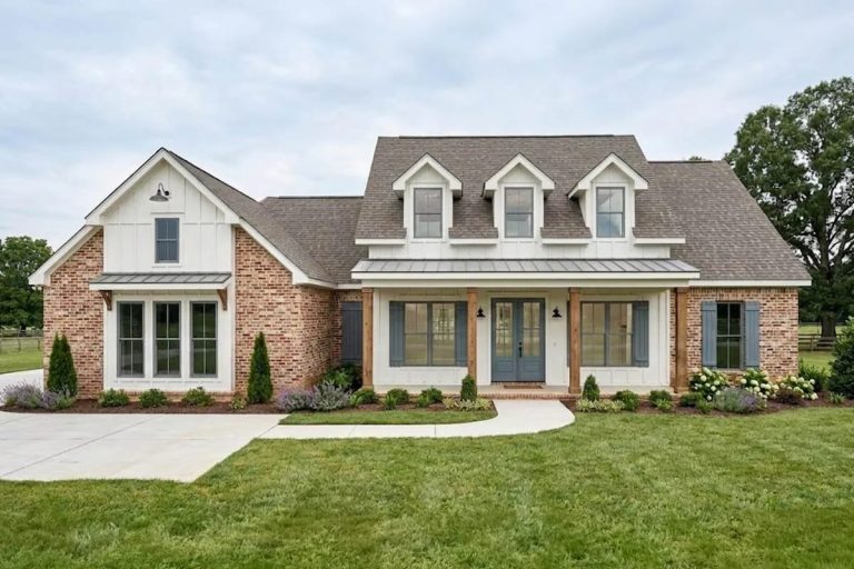 Traditional farmhouse exterior with brick, board-and-batten siding, and a welcoming front porch.