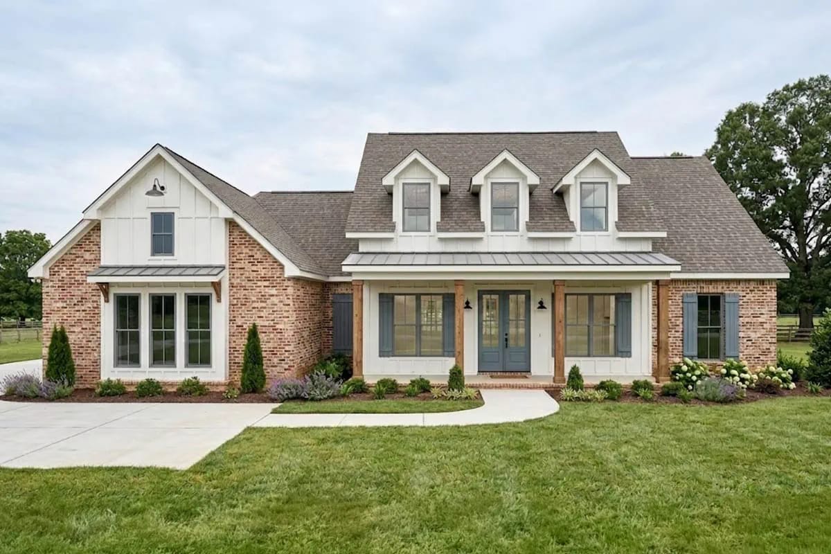 Traditional farmhouse exterior with brick, board-and-batten siding, and a welcoming front porch.