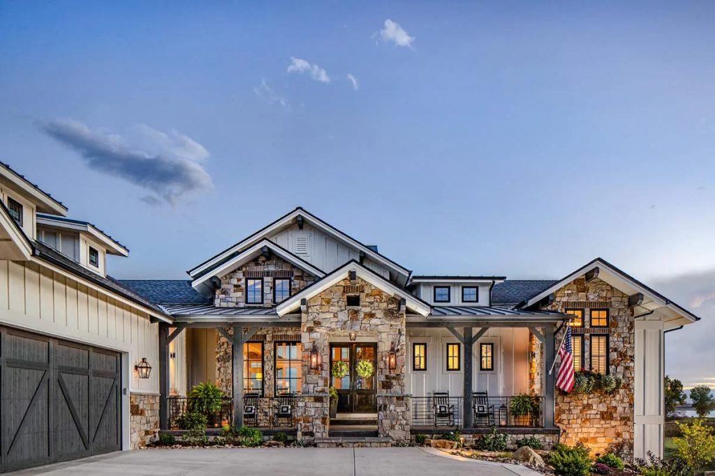 Craftsman-style home with stone and board-and-batten siding, gabled roof, and welcoming front porch
