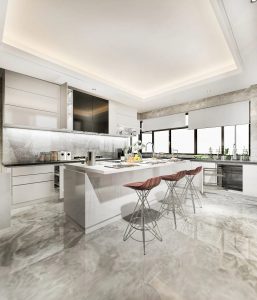 Modern kitchen featuring a full-height stone slab backsplash, sleek white cabinetry, central island with three wooden bar stools, and large windows allowing natural light, illustrating an elegant kitchen idea that remains timeless.