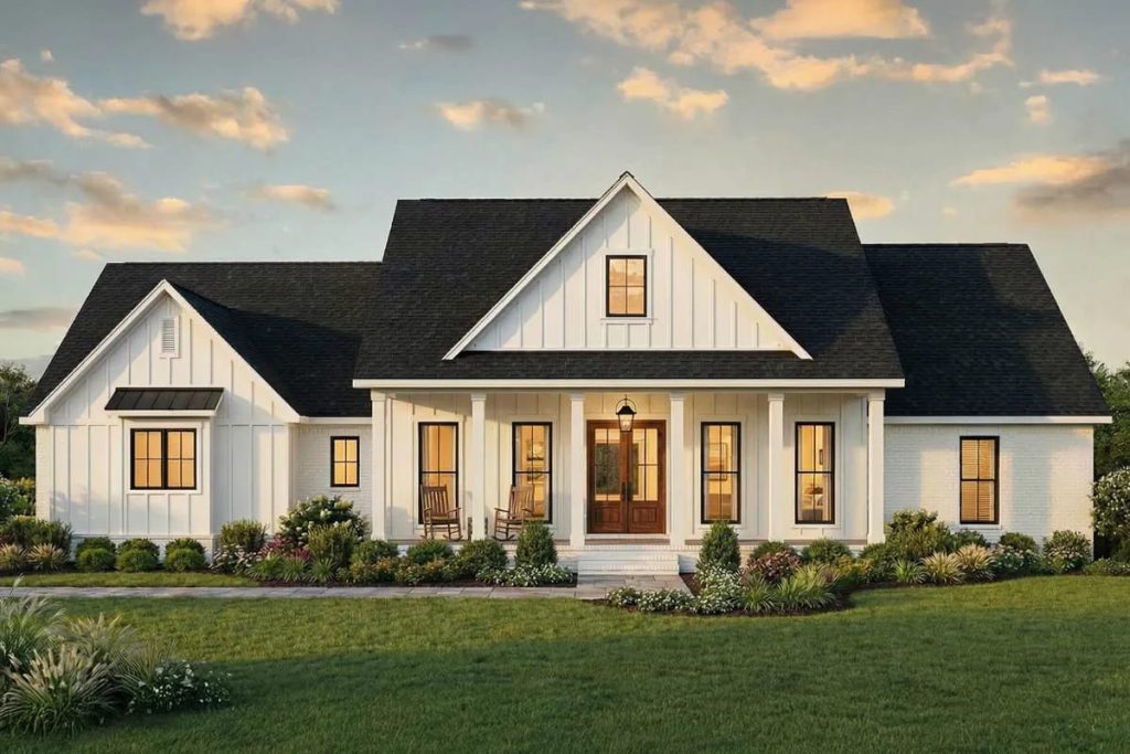 Lovely Harbor 43 Modern farmhouse with white board-and-batten siding, front porch, and gable roof at sunset.
