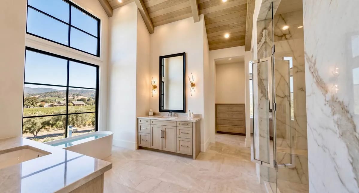 the primary bath under a vaulted plank ceiling 1