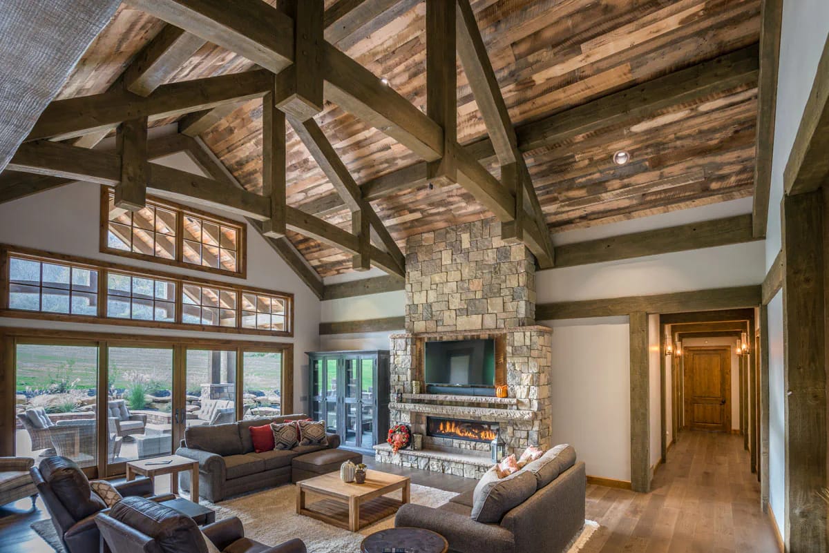 3-Bedroom Mountain Ranch House Plan with an Optional Finished Lower Level (3,623 Sq. Ft. Floor Plan) 6 timber trusses, a plank ceiling, and a great room vaulted to 16 feet 1