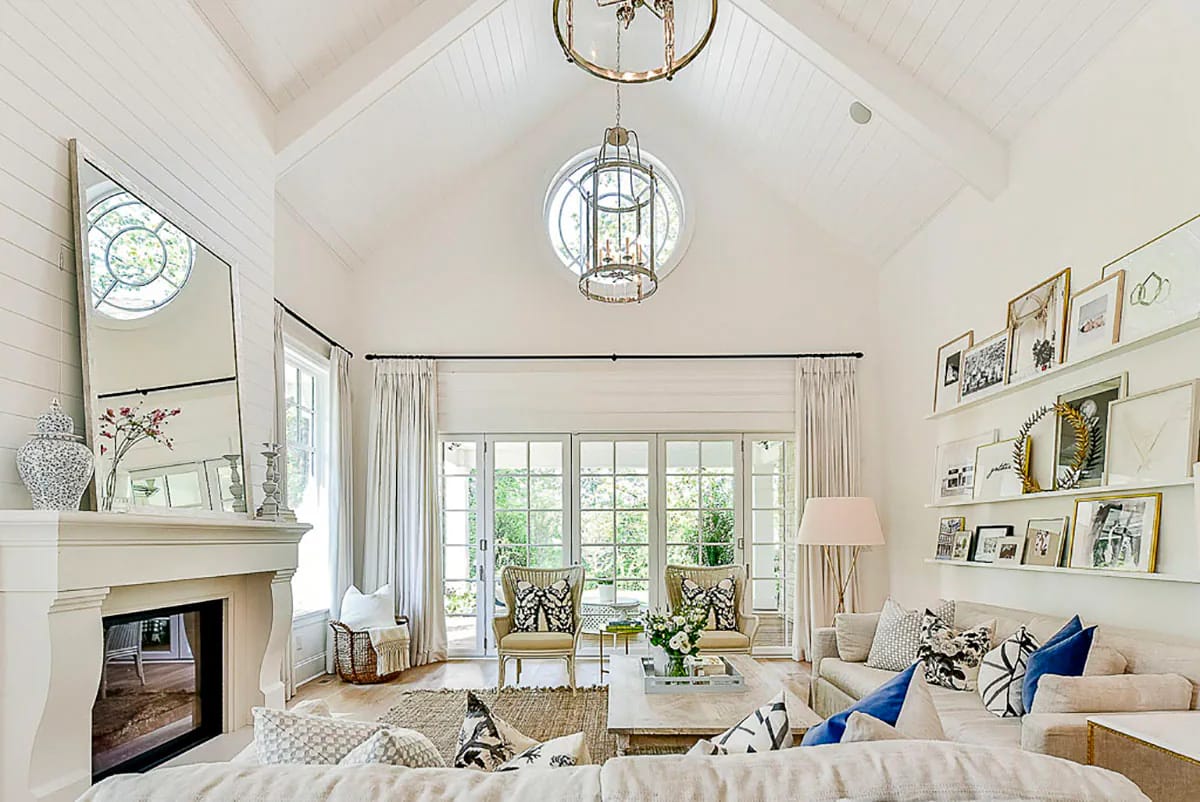 Bright vaulted living room with shiplap ceiling, French doors, fireplace, and neutral decor