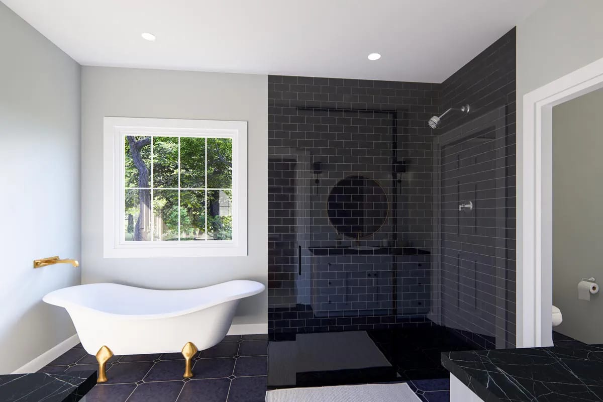Contemporary bathroom with freestanding tub, dark tile shower, double vanity, and leafy window view