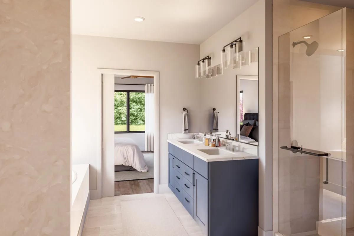 Contemporary bathroom with navy double vanity, glass shower, and bedroom beyond