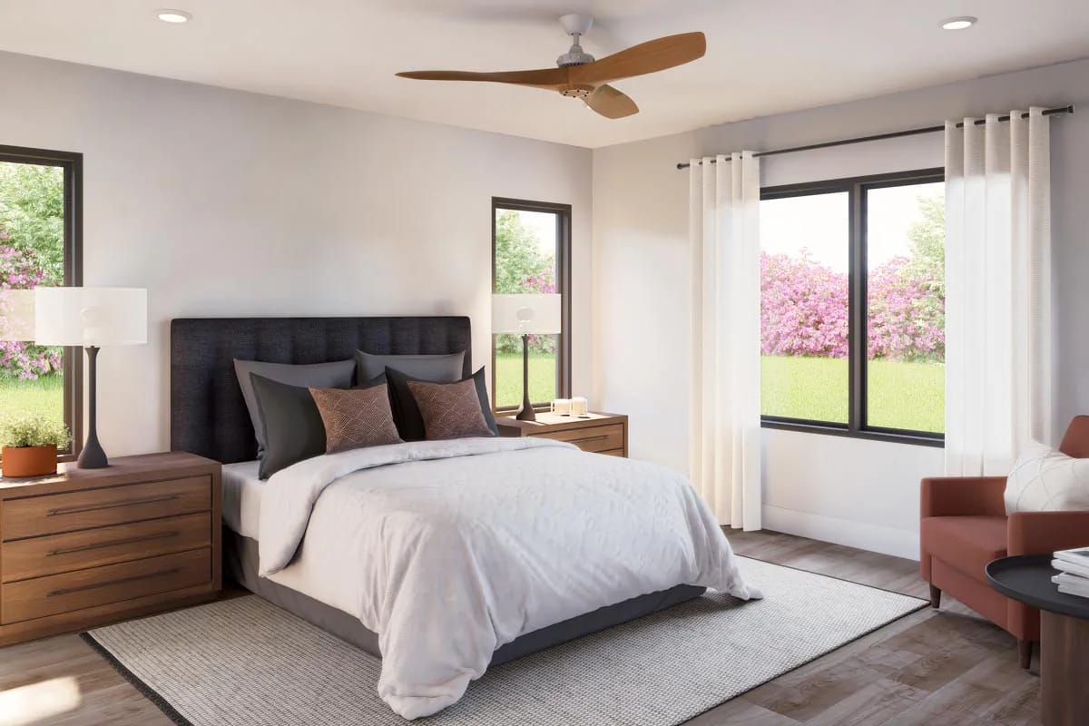 Contemporary bedroom with upholstered bed, wood furniture, large windows, and neutral furnishings