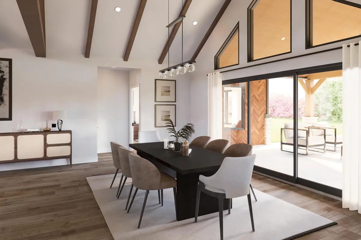 Contemporary dining room with exposed beams, black-framed glass doors, and a covered outdoor terrace