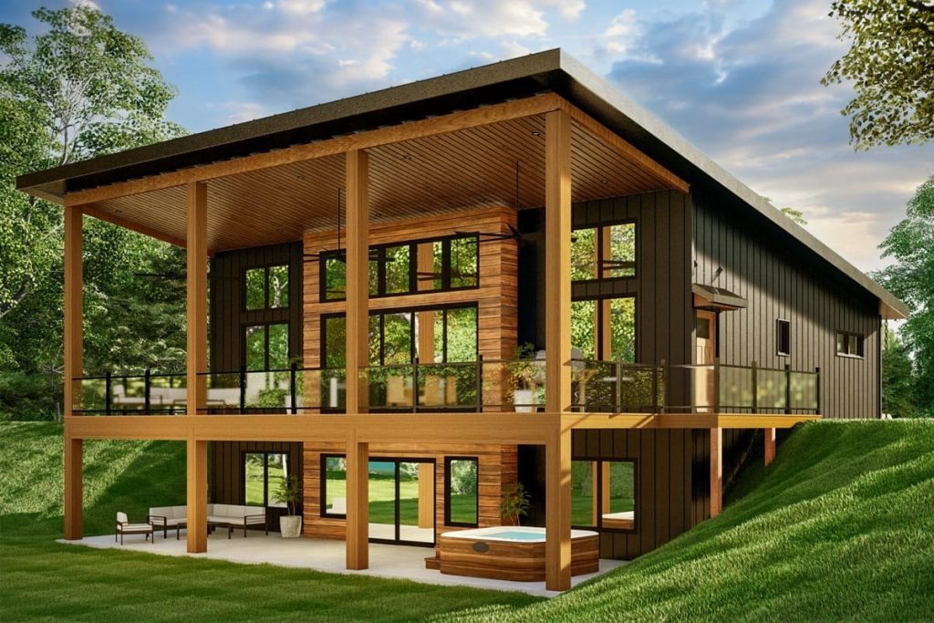 Contemporary two-story home with covered timber terrace, dark siding, large windows, and a lower patio with hot tub