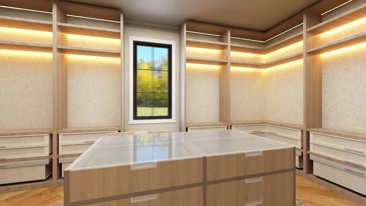 Modern walk-in closet with light wood built-ins, glass island, and accent lighting Modern walk-in closet with light wood built-ins, glass island, and accent lighting