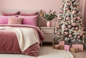 Pink Christmas Decor for a Bedroom That Still Looks Like a Bedroom 4 Pink Christmas decor for a bedroom featuring a pink velvet bed, textured white throw, frosted Christmas tree with pink ornaments and cream ribbons, bedside table, lamp, plant, and wrapped presents