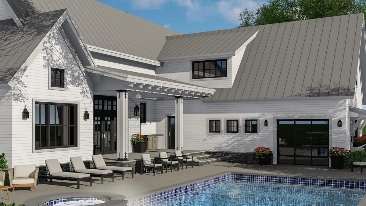 Rear courtyard of a white-sided home with metal roofs, pool, spa, pergola, and outdoor seating