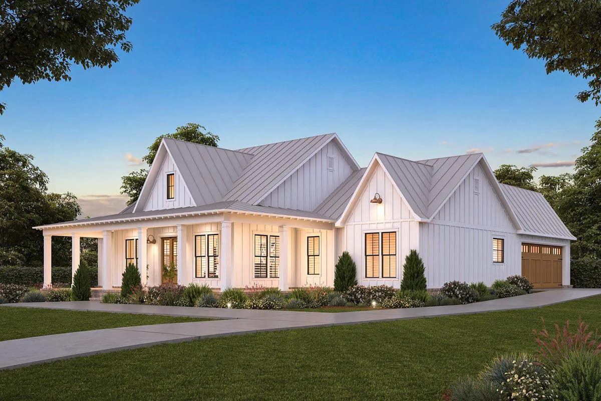 White farmhouse with intersecting gables, covered porch, metal roof, landscaping, and side-facing garage White farmhouse with intersecting gables, covered porch, metal roof, landscaping, and side-facing garage