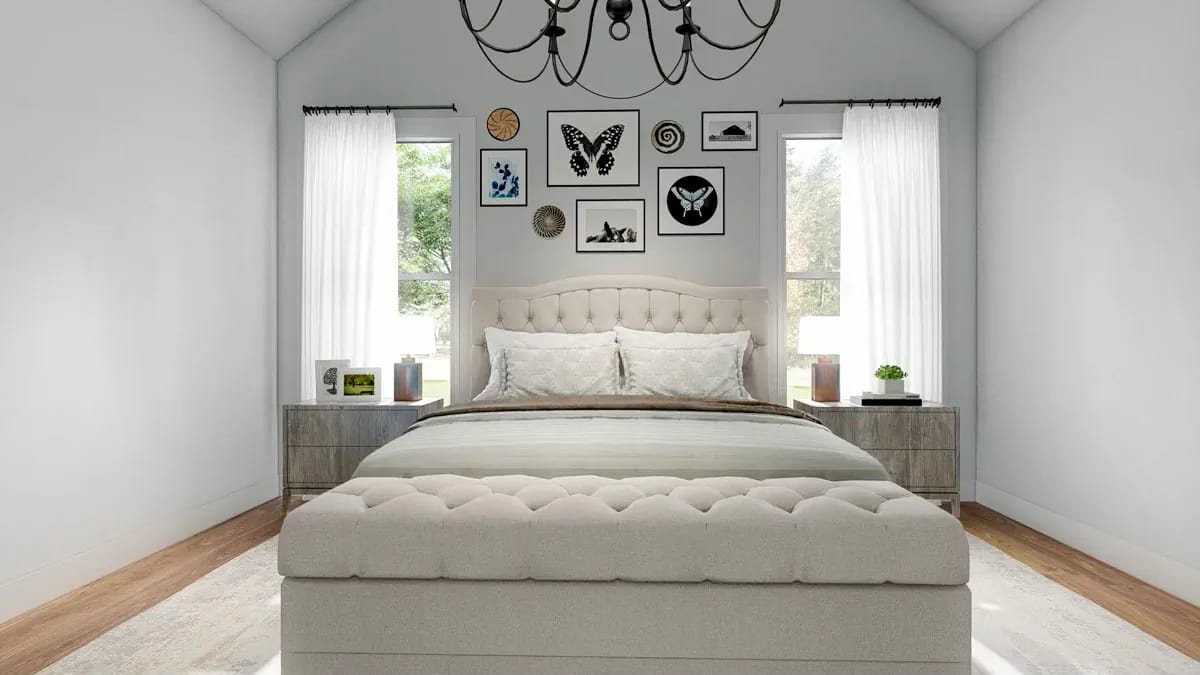 Bright bedroom with tufted bed, sheer-curtained windows, gallery wall, and dark chandelier