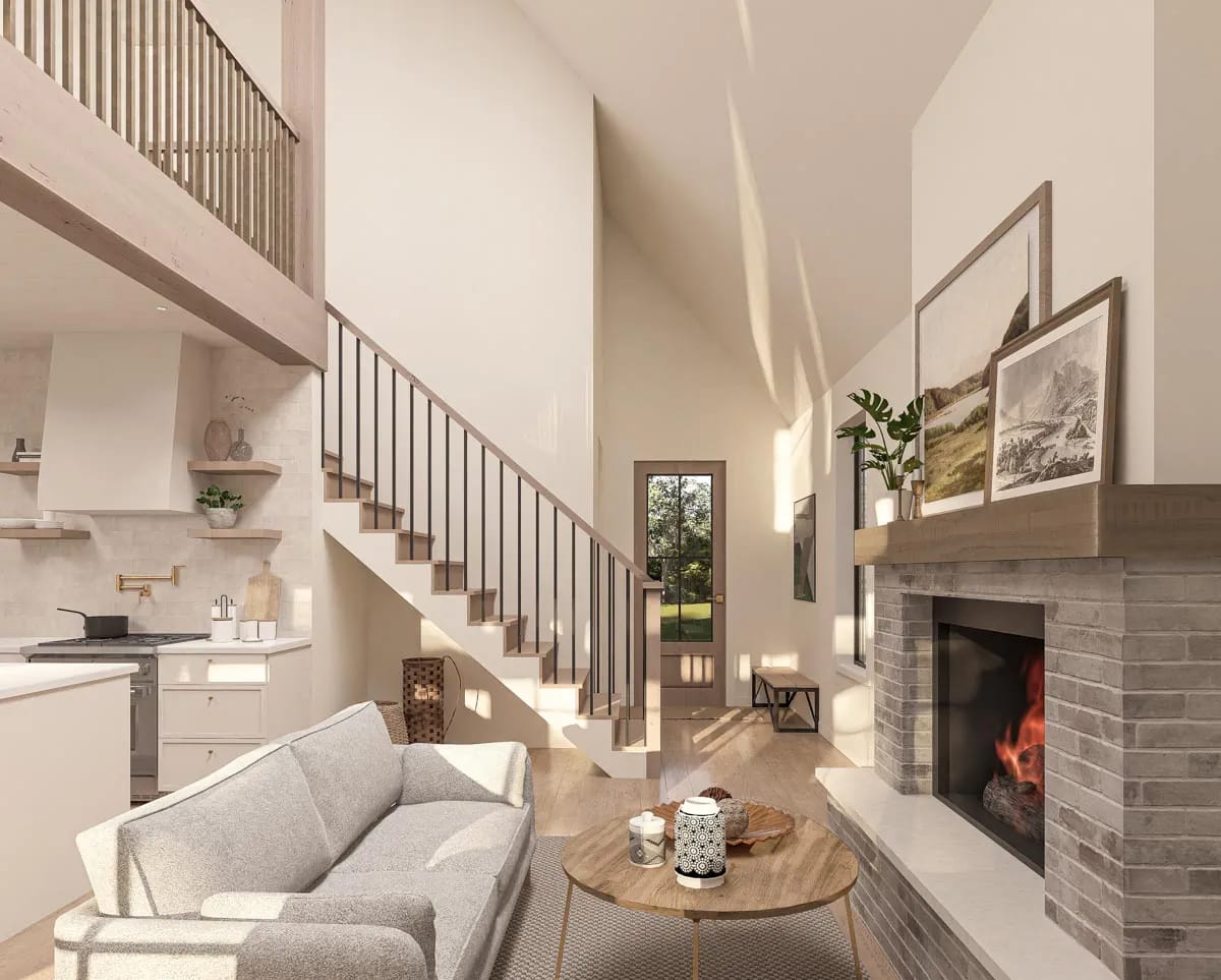 Bright double-height living room with brick fireplace, open stair, compact kitchen, and tall glazed door Bright double-height living room with brick fireplace, open stair, compact kitchen, and tall glazed door
