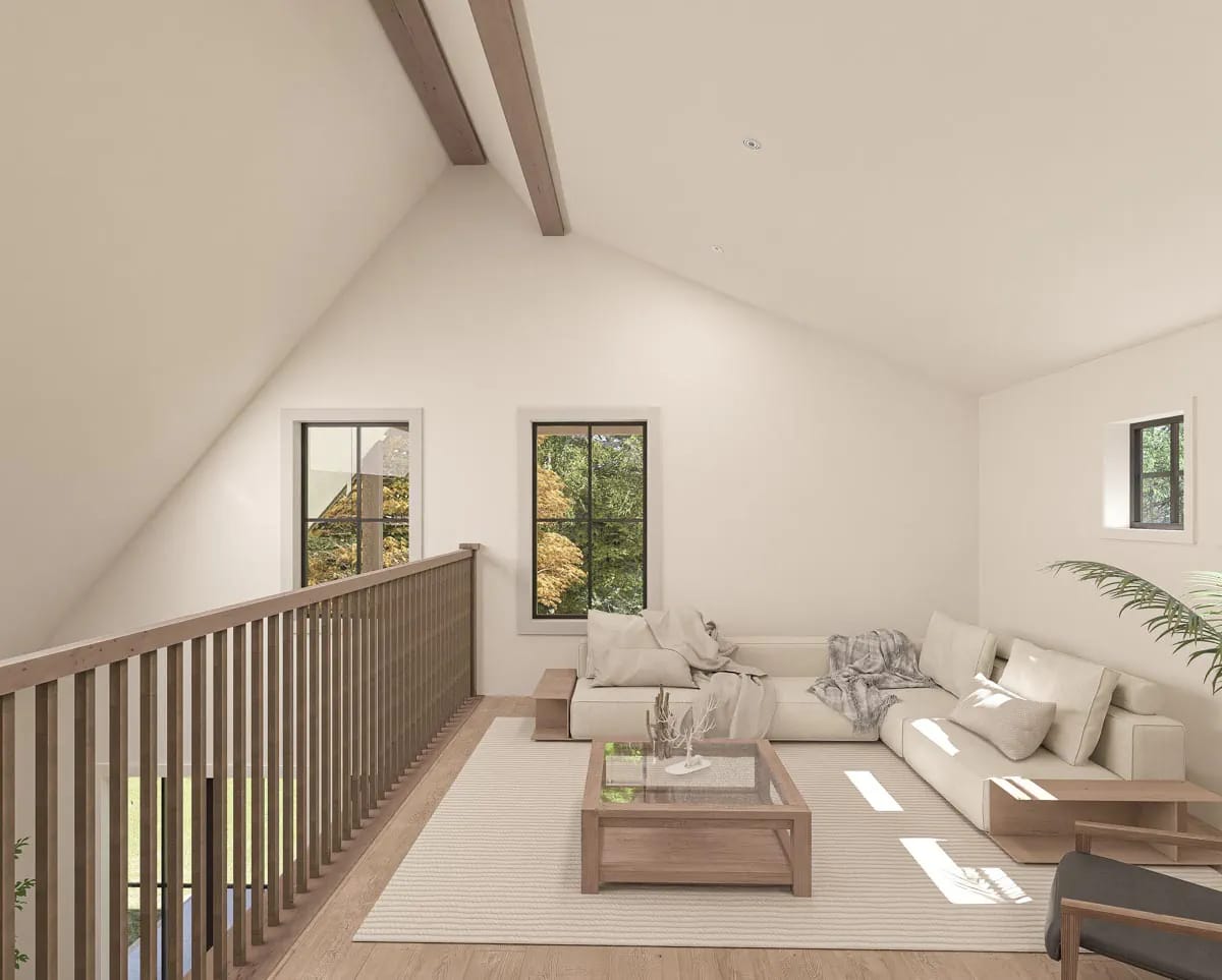 Bright vaulted sitting area with exposed beams, cream sectional, wood furnishings, and black-framed windows Bright vaulted sitting area with exposed beams, cream sectional, wood furnishings, and black-framed windows
