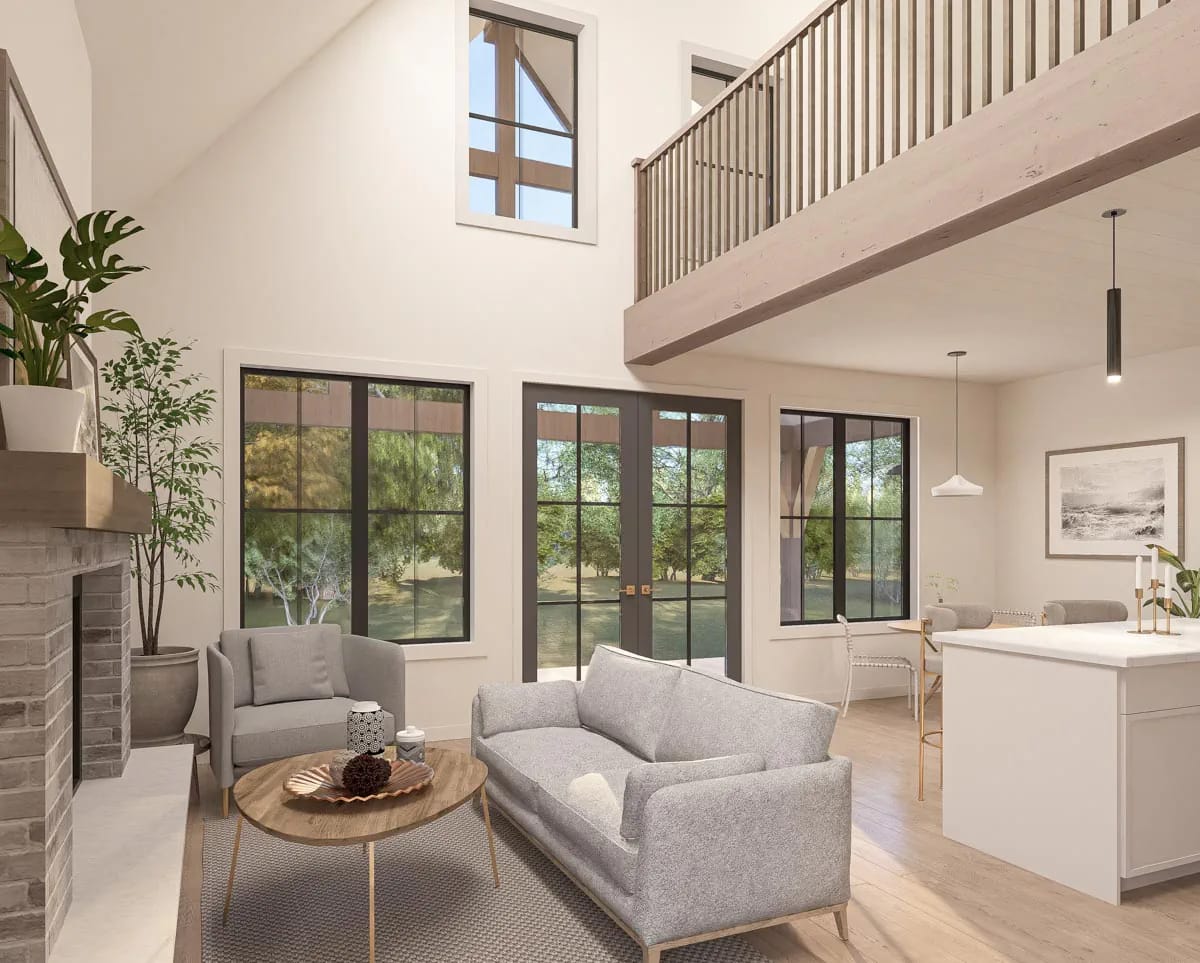 Double-height modern living room with fireplace, gray seating, white island, and black-framed windows Double-height modern living room with fireplace, gray seating, white island, and black-framed windows