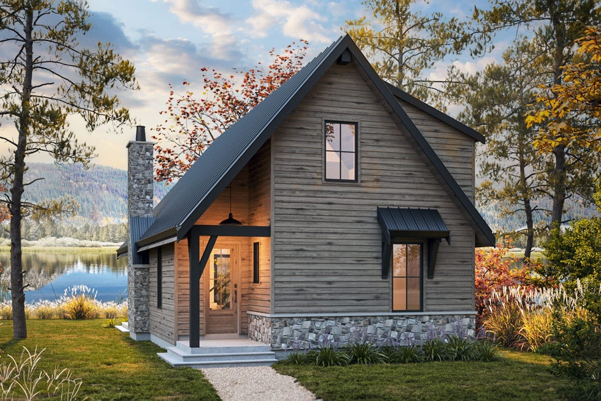 2-Bedroom Mountain Cottage House Plan with a Two-Story Great Room and Loft (1,364 Sq. Ft. Floor Plan) 1 Steep-gabled lakeside cottage with weathered wood siding, stone base, covered entry, and dark metal roof